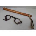 A wooden truncheon and a pair of handcuffs