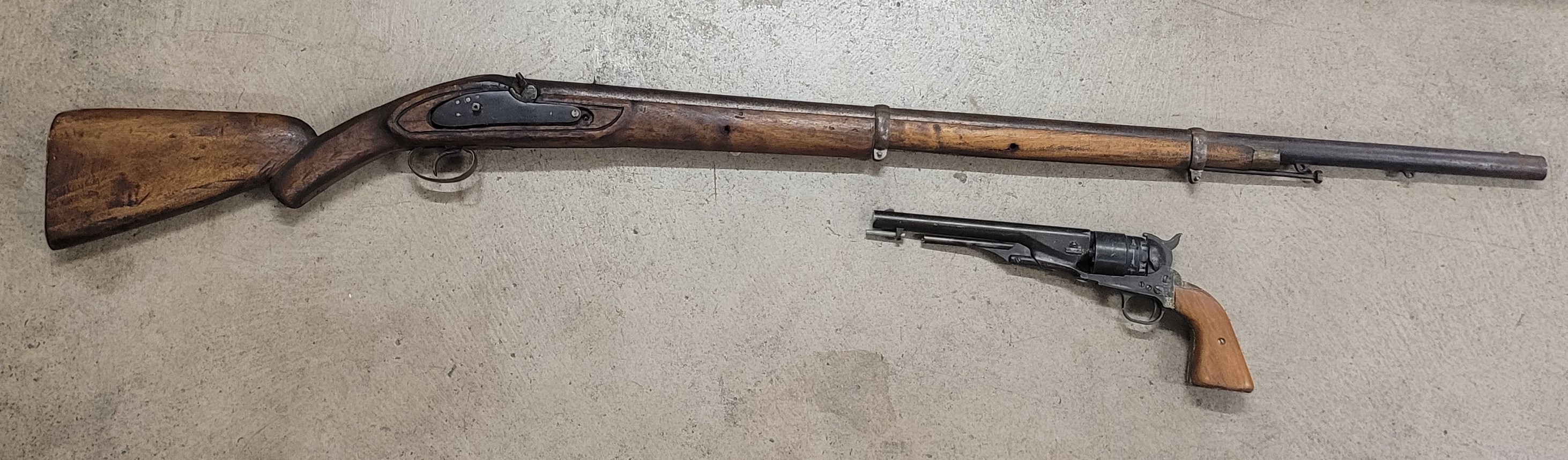 An Indian two band Enfield percussion rifle and a revolver