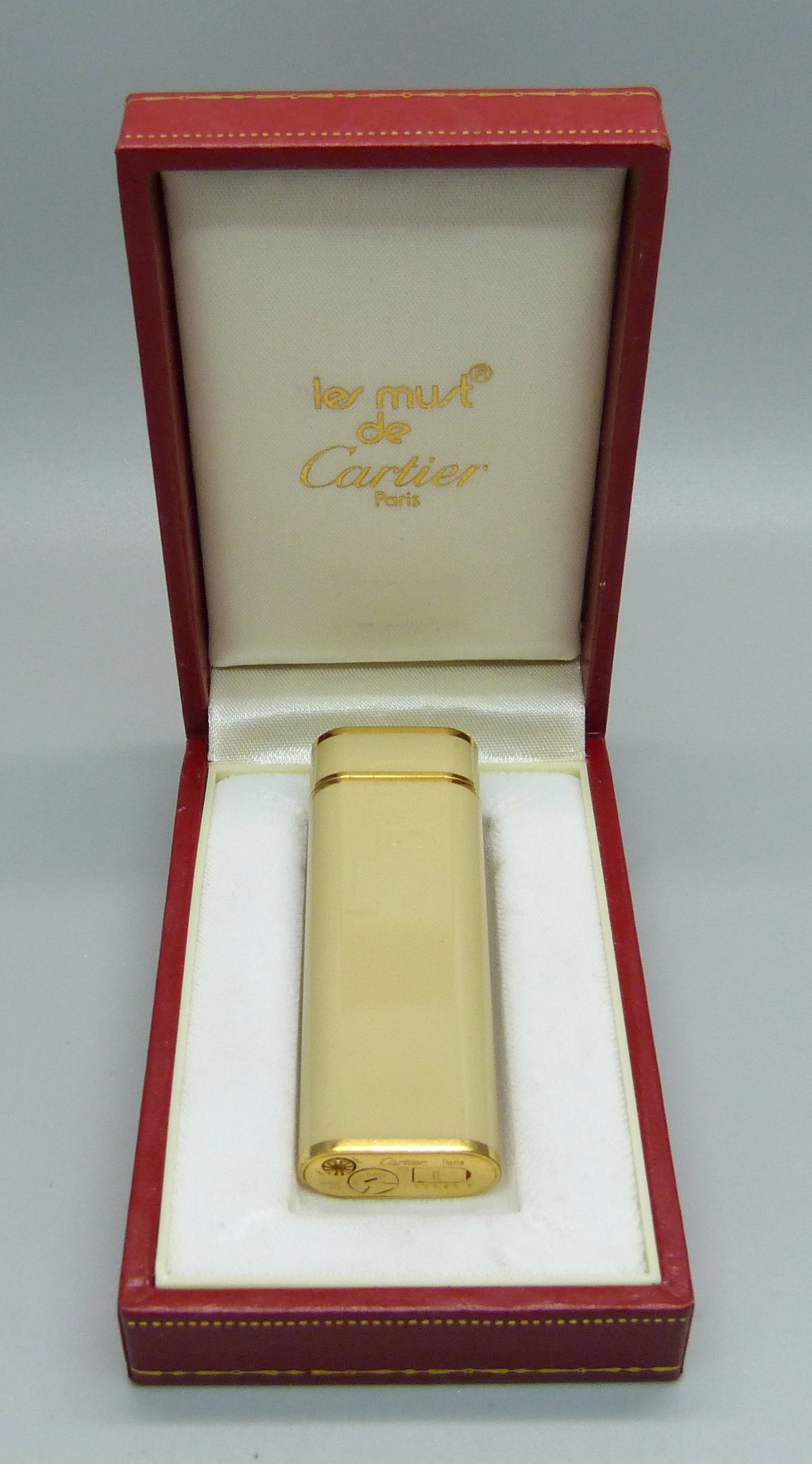 A Cartier lighter in original box with spare Cartier flints