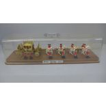 A model of a Queen Elizabeth II Silver Jubilee 1977 coach and horses in a perspex case