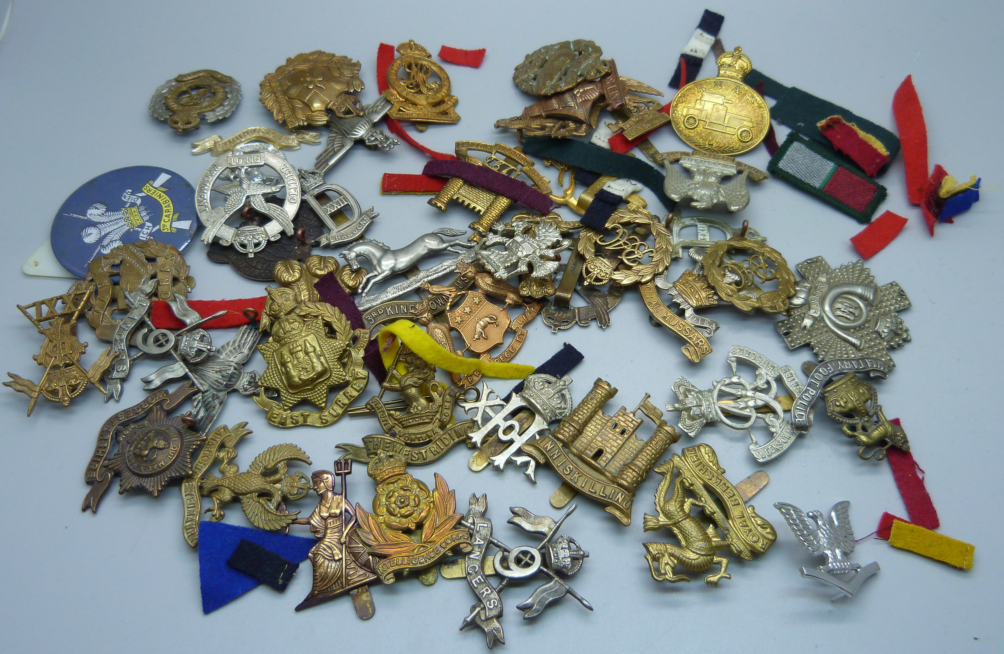 A collection of British military cap badges including some by Gaunt