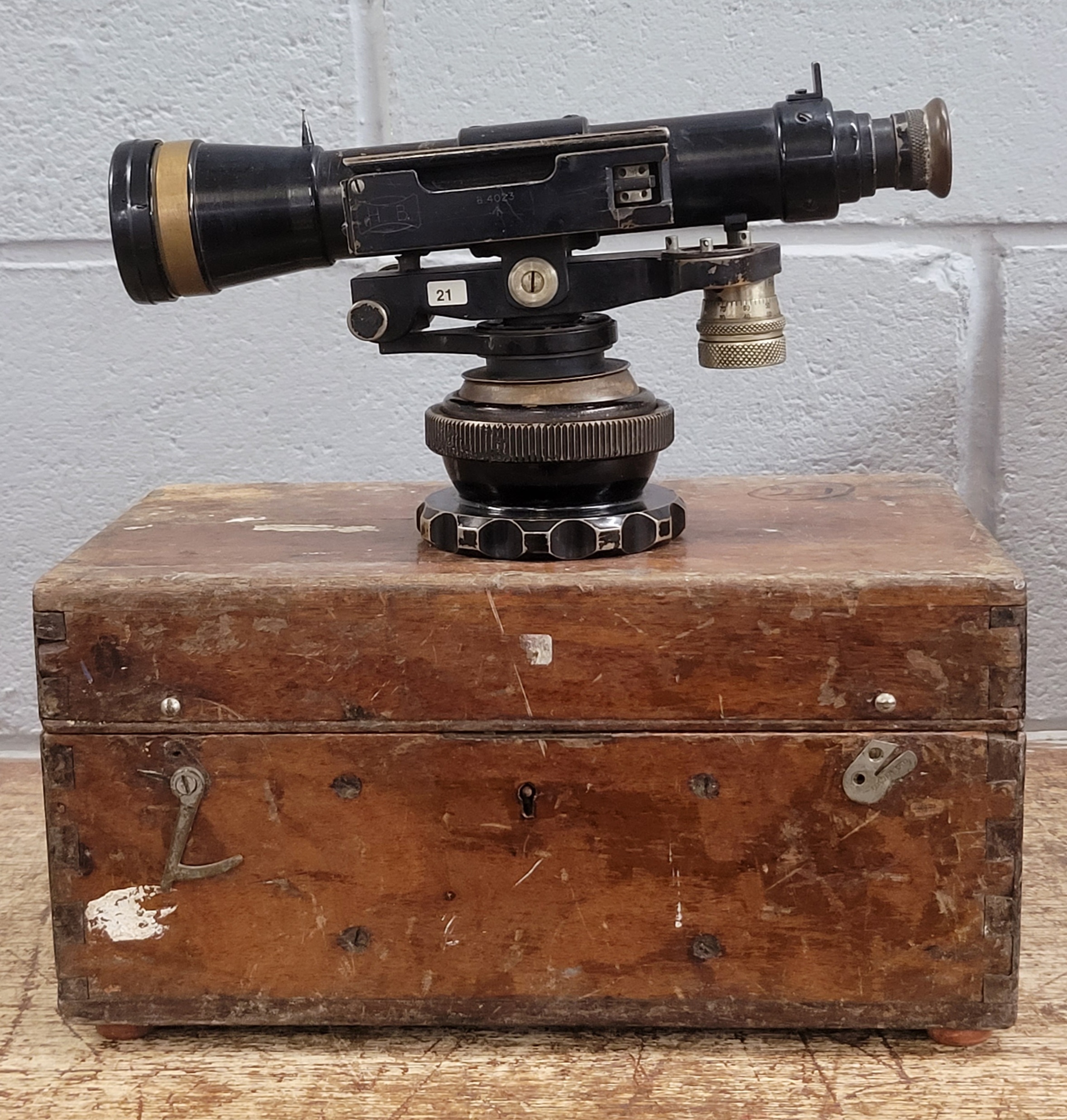 A military artillery gun sight, in wooden case