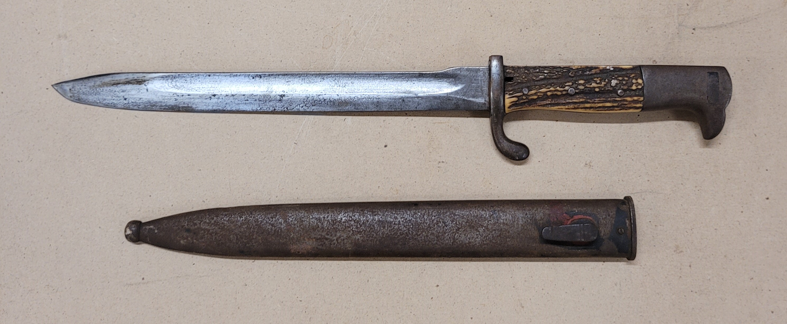 A bayonet with antler handle and scabbard