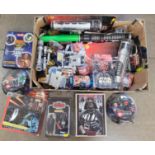 A collection of Star Wars items, toys, figures, etc.