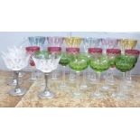 Coloured drinking glasses; a set of six wine, six cranberry flash cut sherry, eight small green hock