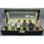 Six wristwatches in a display case including Sekonda and Lorus