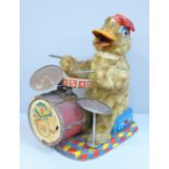 An Alps Japan 1940s tin plate duck playing the drums, with batteries in working condition