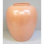 A Poole pottery salmon pink lustre vase, 22cm