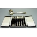 A silver ladle and a cased set of six silver coffee spoons, 102g