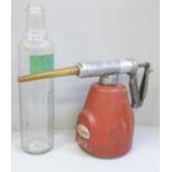 A BP Energol motor oil bottle and an Esso UCL oil dispenser