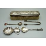 A silver tea caddy spoon, a pair of silver sugar bows, a silver backed brush and two spoons