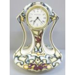 A Moorcroft limited edition Black Ryden clock, Time Flight pattern, 65/100, signed K. Goodman, 25cm