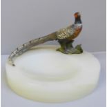 A cold painted bronze model of a pheasant on an onyx ashtray