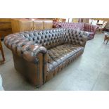 A chestnut brown leather Chesterfield settee