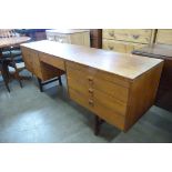 An Alfred Cox teak desk