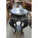 A Chinese carved ebonised jardiniere stand