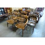 A set of eight early 20th Century elm and beech smokers bow chairs
