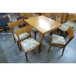 An oak draw leaf dining table and four chairs