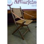 A Victorian campaign style faux bamboo and bergere folding chair