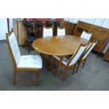 A teak extending dining table and six chairs