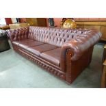 An oxblood red leather Chesterfield settee