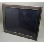 A silver photograph frame, 30cm x 25cm approximate