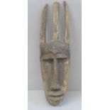 An African carved wooden mask, 44cm