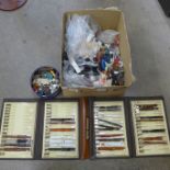 A box of vintage buckles, buttons and a folder of watch straps