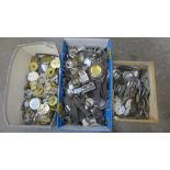 A box of wristwatch case backs and bezels and a collection of pocket watch dials and parts