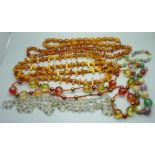 A collection of bead necklaces including amber