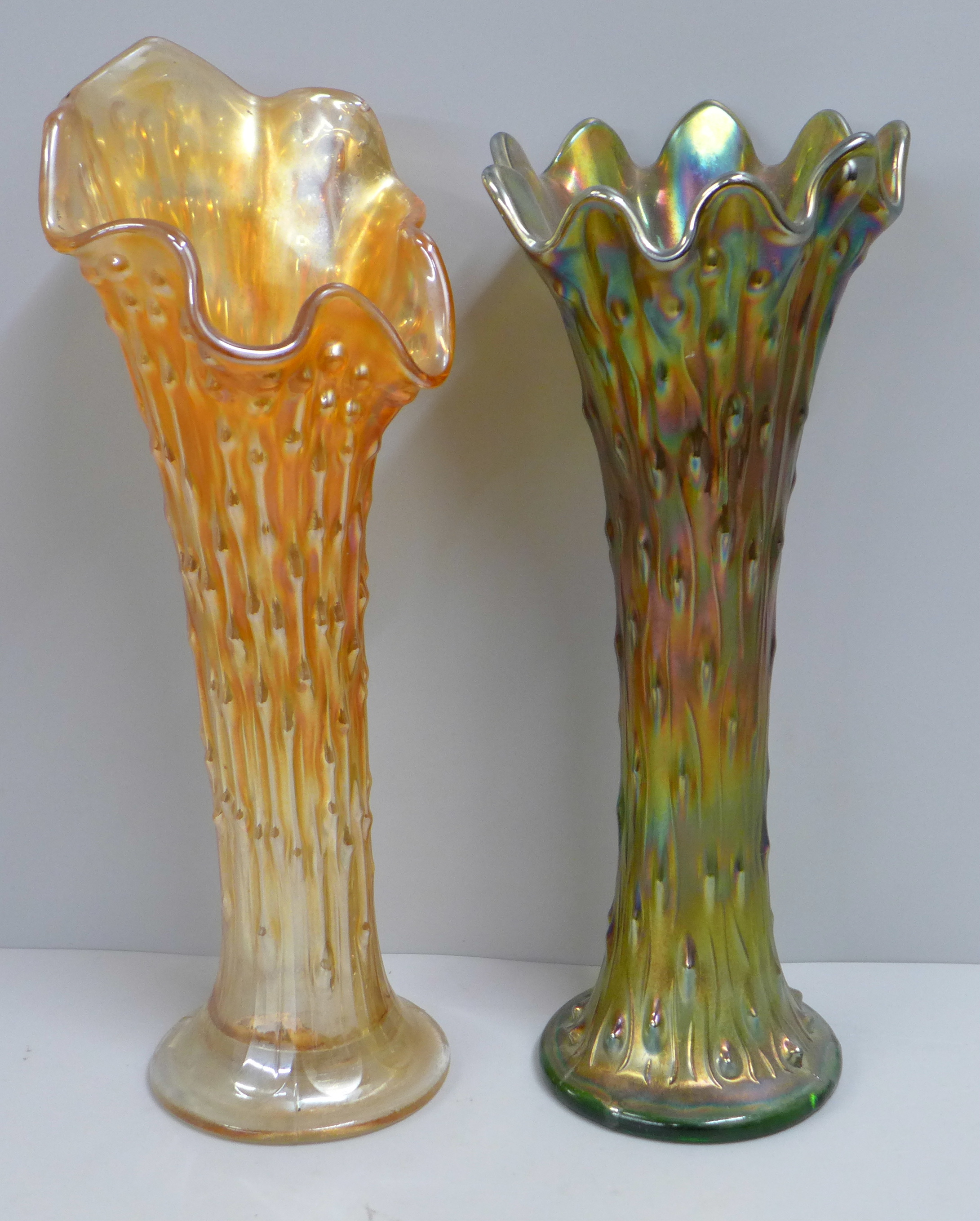 A Northwood iridescent carnival glass tree trunk vase and one other similar in marigold, base