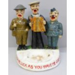A WWII figural ashtray, Army, Navy and RAF