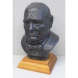 A 9" (23cm) bust of Winston Churchill on a wooden base