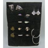 Eight silver rings, a pair of silver earrings, two pairs of white metal earrings, and a pair of