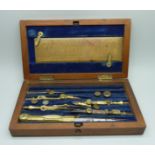 A technical drawing set in a wooden case, some instruments missing