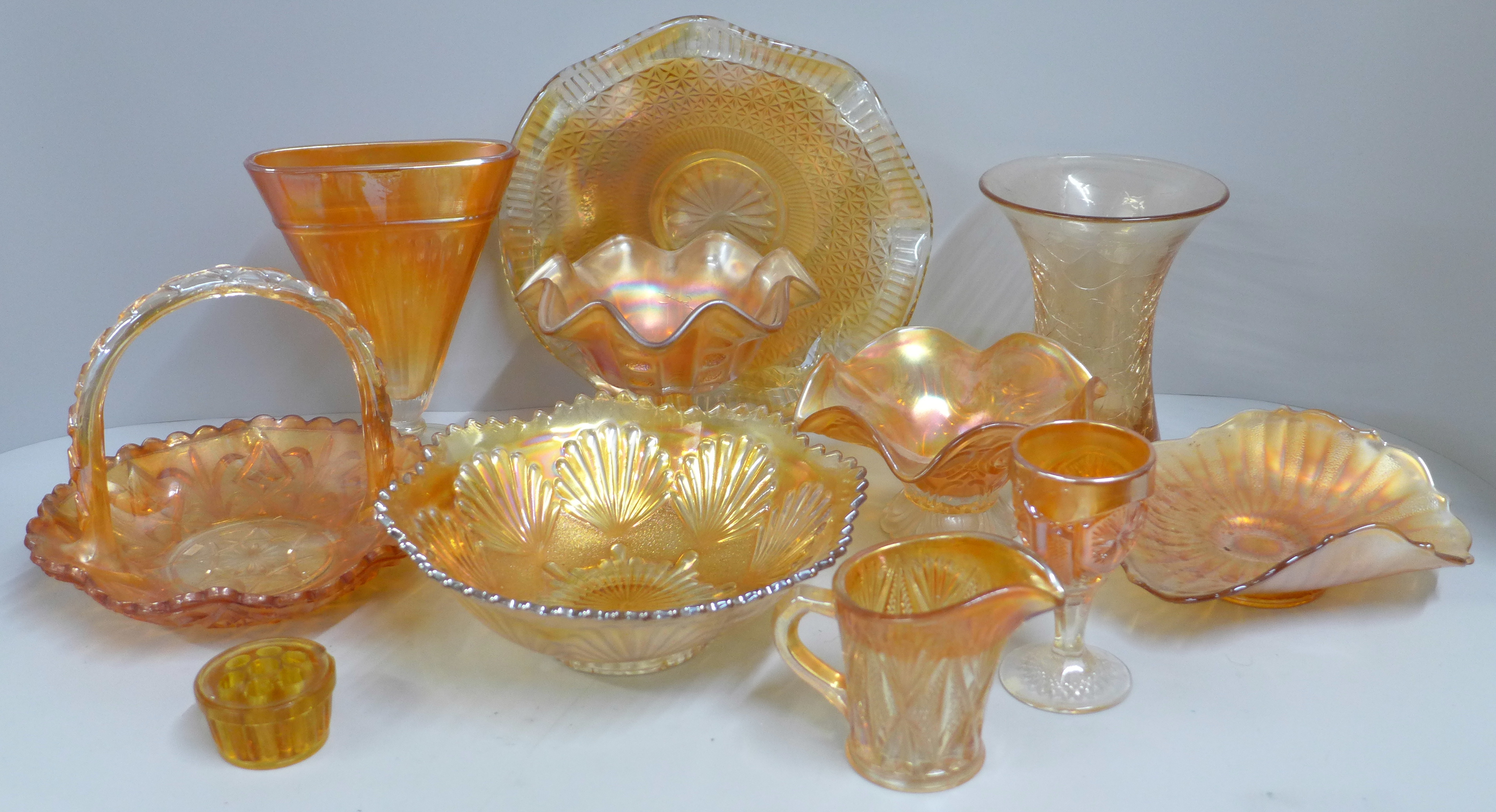 Ten items of marigold carnival glass, a crackle glaze celery vase, iridescent dished and bowls,