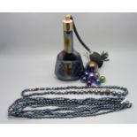 An iridescent carnival glass atomiser, two necklaces and marbles