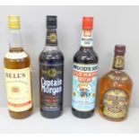 Four bottles of alcohol; Captain Morgan Original Rum, Woods 100 Old Navy Rum, Chivas Regal Scotch