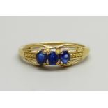 A silver gilt and three blue stone ring, T