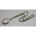 A Victorian silver locket and chain, locket hallmarked Chester 1881, locket 27mm wide, chain