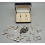 Eleven pairs of silver earrings