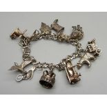 A silver charm bracelet, one charm set with an opal, 61g