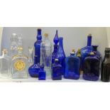 A collection of glass bottles including Bristol blue and green glass