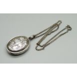 A white metal locket on a silver chain