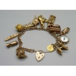 A 9ct gold charm bracelet, with twelve hallmarked 9ct gold charms and a yellow metal charm, 73.3g