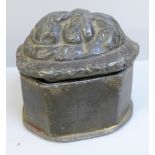 A lead casket, 8.5cm tall