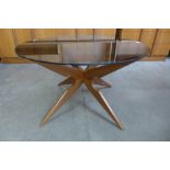 A Danish Sika Mobler teak and glass topped circular spider leg coffee table, designed by Vladimir