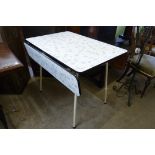 A vintage Formica topped drop-leaf kitchen table
