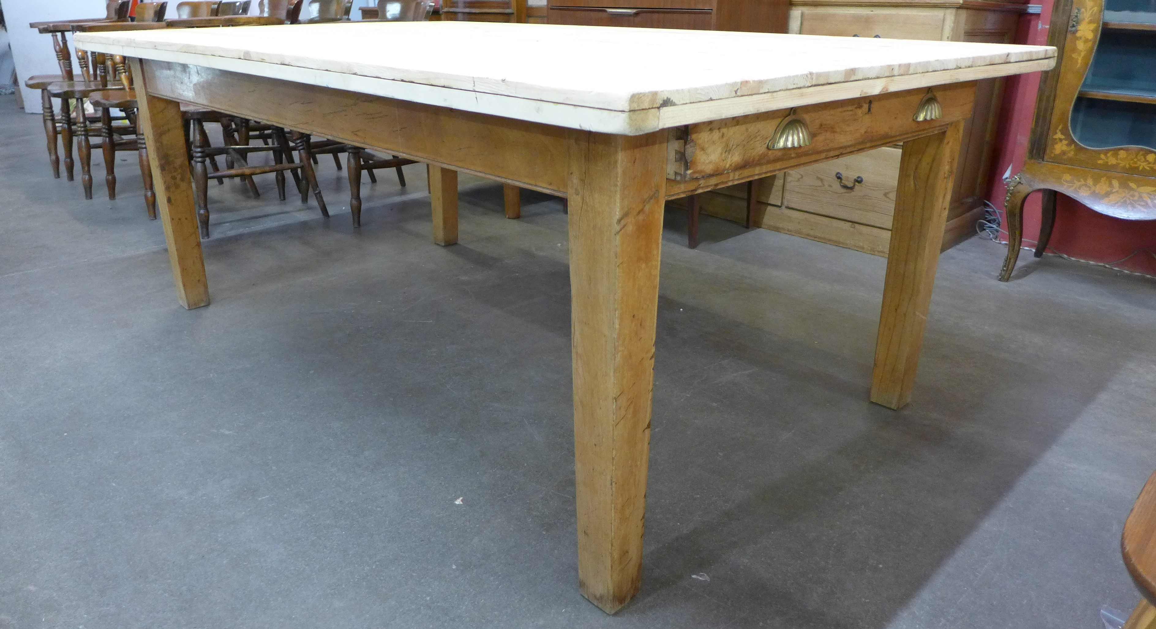 A large 19th Century and later pine two drawer farmhouse kitchen table