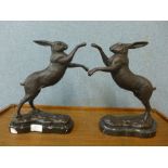 A pair of French style bronze figures of boxing hares, on black marble socles